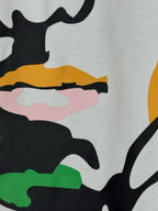 White graphic T-shirt fabric detail with colorful face features