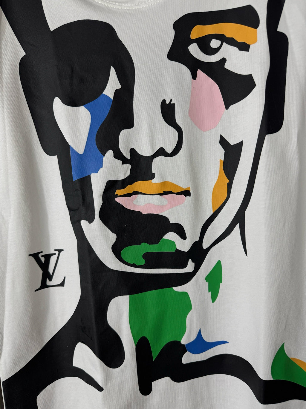 White graphic T-shirt with close-up colorful face and bold black shapes