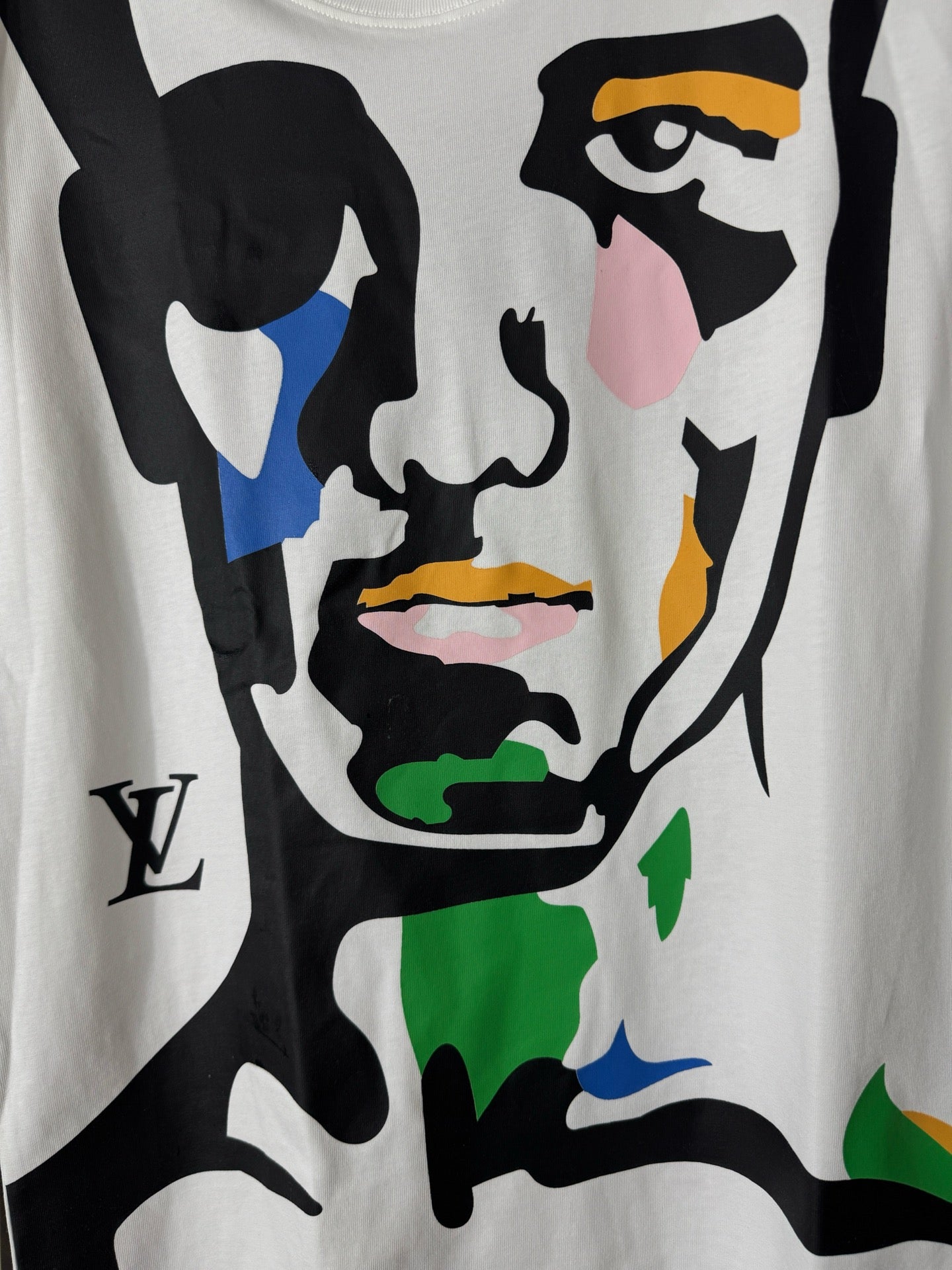 White graphic T-shirt with close-up colorful face and bold black shapes