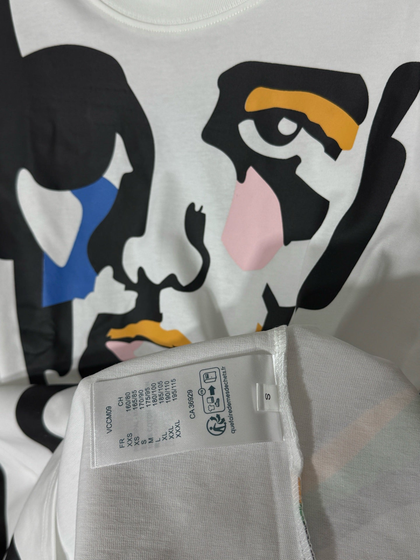 White graphic T-shirt with neckline care label and hanging string tag