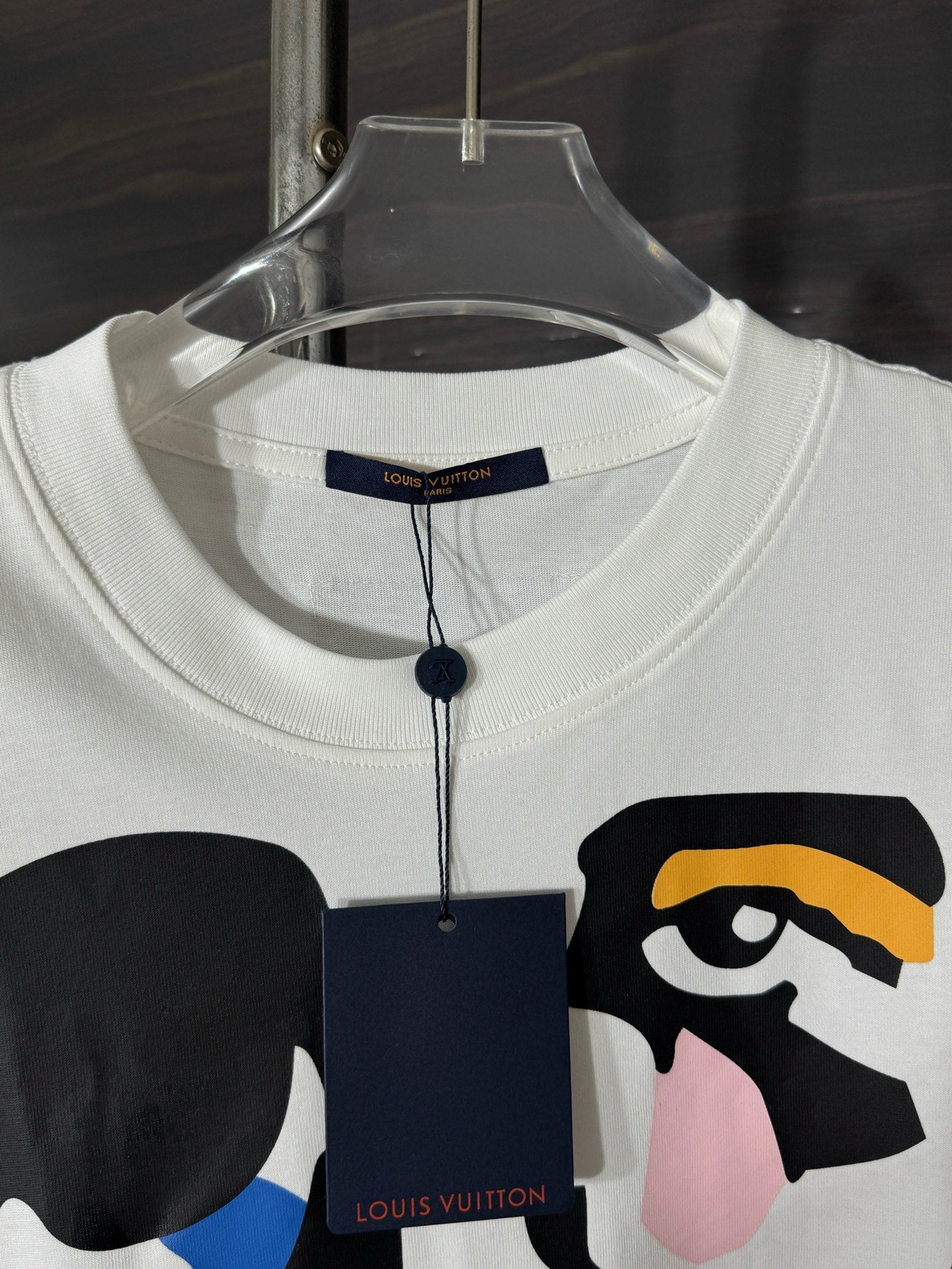 White crewneck T-shirt with brand neck tag and colorful face graphic