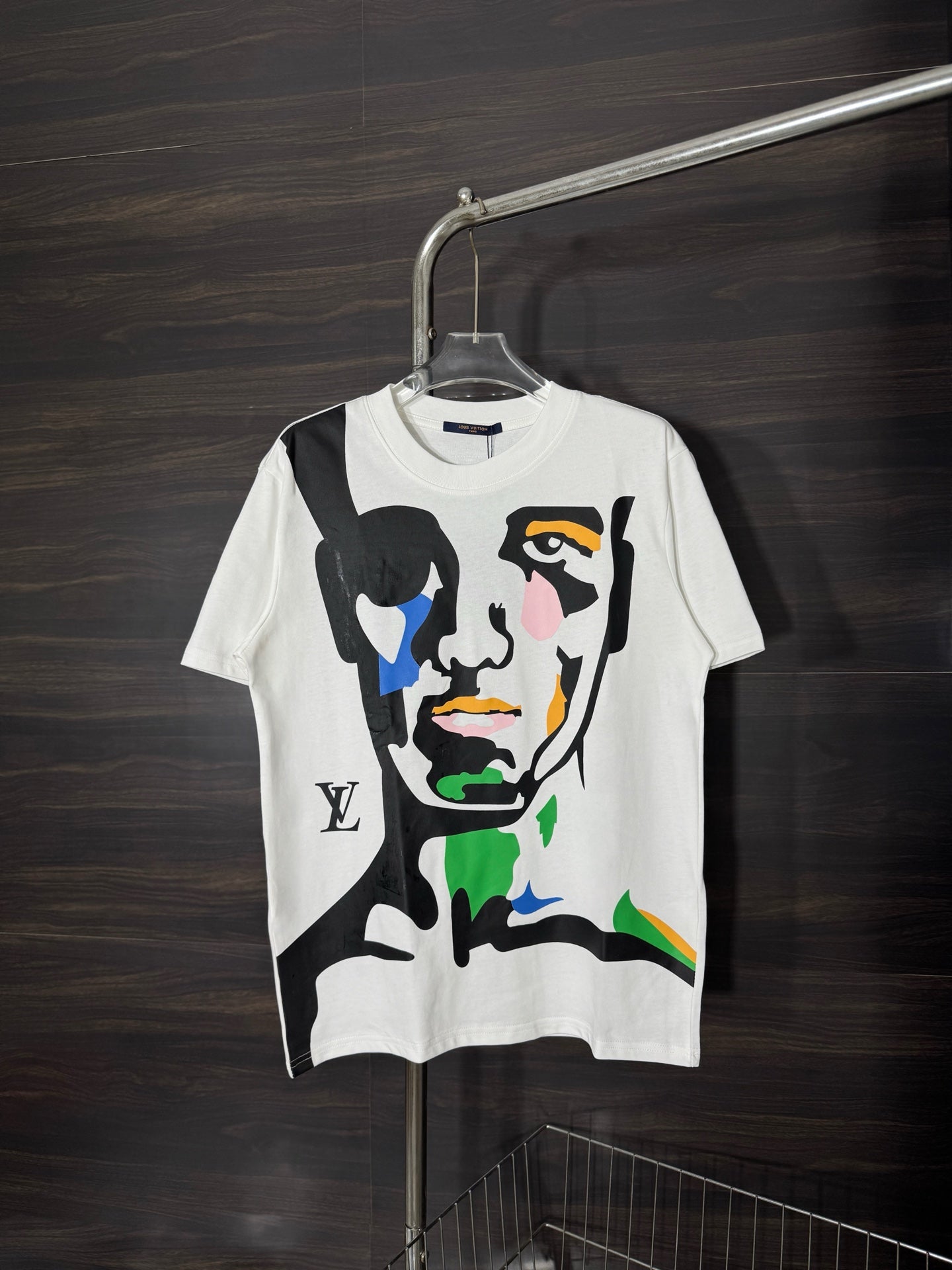 White graphic T-shirt with colorful face illustration on front