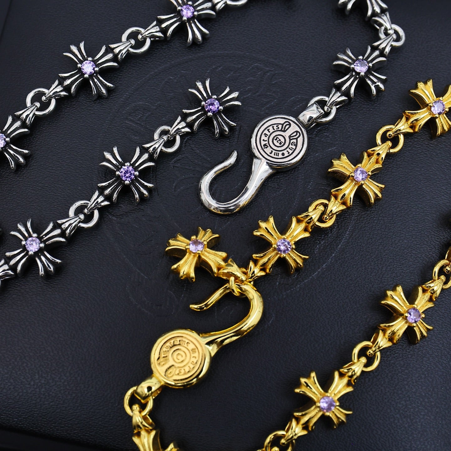 Silver and gold charm bracelets with purple flower links and clasp charm