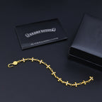 Gold charm bracelet with purple accents and a silver polishing cloth card