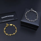 Silver and gold charm bracelets with purple accents and silver polishing cloth