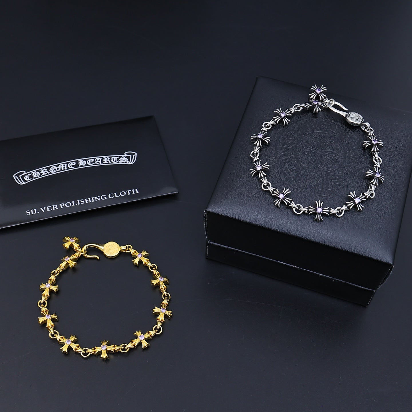 Silver and gold charm bracelets with purple accents and silver polishing cloth