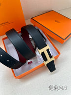 Navy leather belt with silver H buckle displayed in orange gift box set.