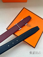 Burgundy and navy leather belts with silver H buckles in orange box.