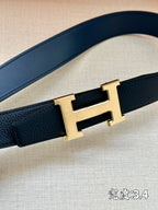 Hermes belt strap detail with dark navy leather and gold-tone H buckle