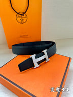 Hermes belt with dark navy leather strap and gold-tone H buckle detail
