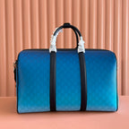 Gucci bag blue GG pattern with black center stripe and top handles.