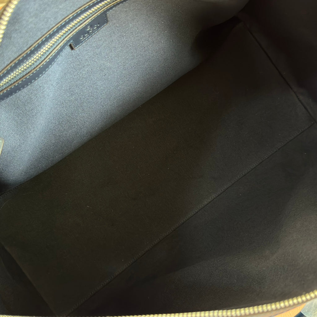 Gucci bag interior lining in dark tone with visible seam stitching.