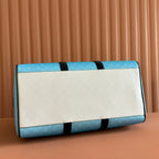 Gucci bag blue GG pattern with cream front panel and black leather trim.