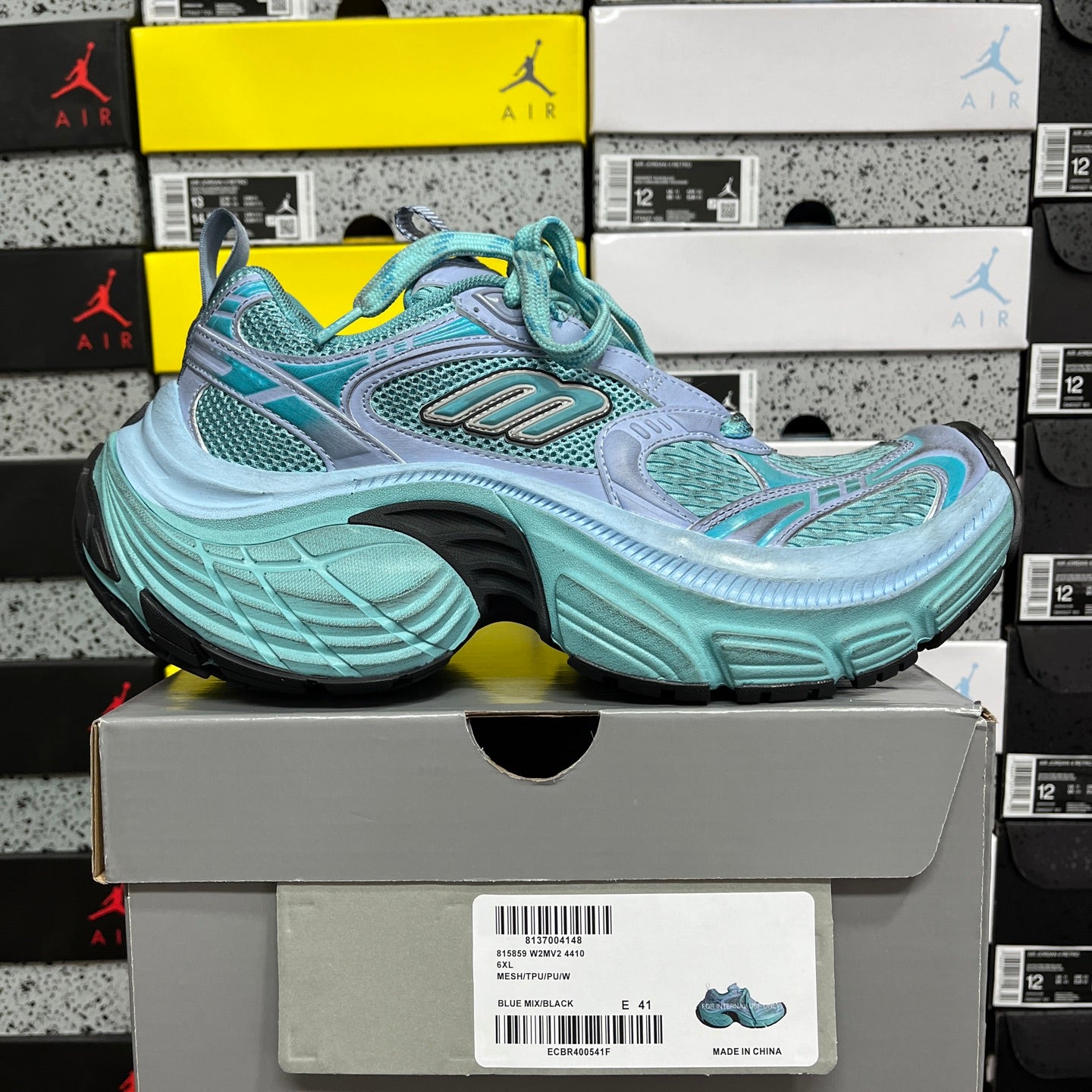 Teal and light blue mesh athletic sneakers with lace-up front and thick sole