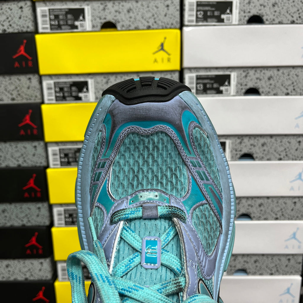 Teal athletic sneaker toe box with lace-up front and textured upper