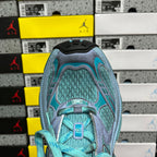 Teal athletic sneaker toe box with lace-up front and textured upper