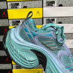 Teal and light blue athletic sneaker with lace-up closure and sculpted sole