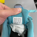 Balenciaga size label inside teal sneaker collar, with lace and padding