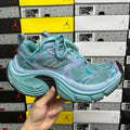 Teal and light blue athletic sneakers with teal laces and chunky rubber sole