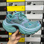 Teal and light blue athletic sneakers with teal laces and chunky rubber sole