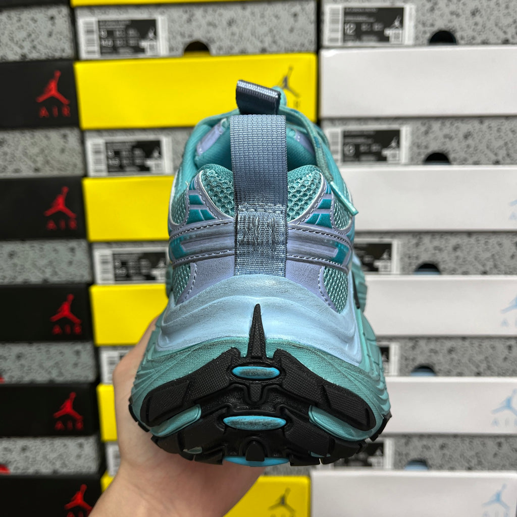 Teal athletic sneaker heel view with contrast trim and rubber tread