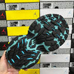 Black outsole with teal tread patterns for traction athletic sneaker