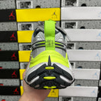 Grey running sneaker heel view, neon yellow midsole band and treaded outsole