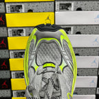 Grey running sneaker interior view, mesh tongue and neon yellow trim