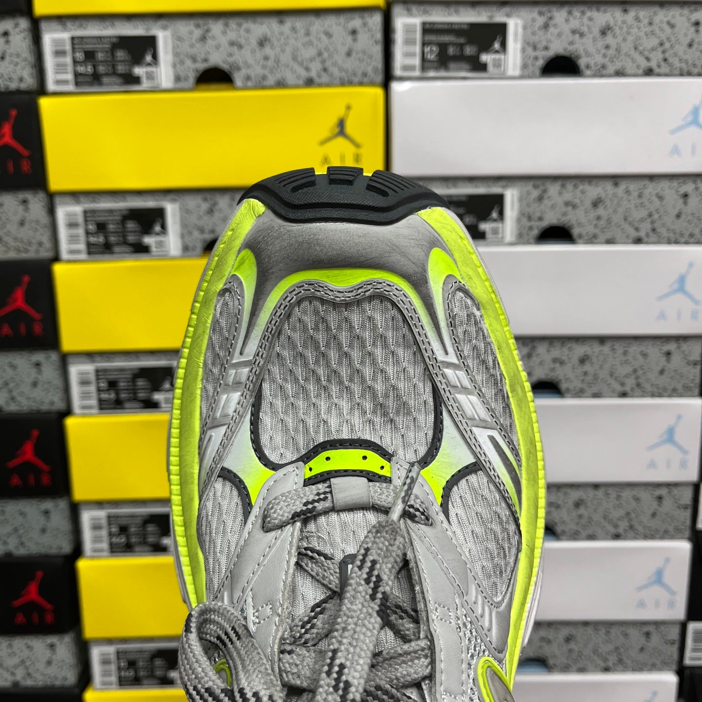 Grey running sneaker interior view, mesh tongue and neon yellow trim
