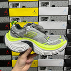 Grey and neon yellow running sneaker, front three-quarter view with chunky sole