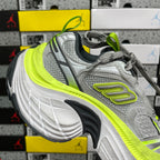 Grey running sneaker, lace-up front with neon yellow accent and outlined logo