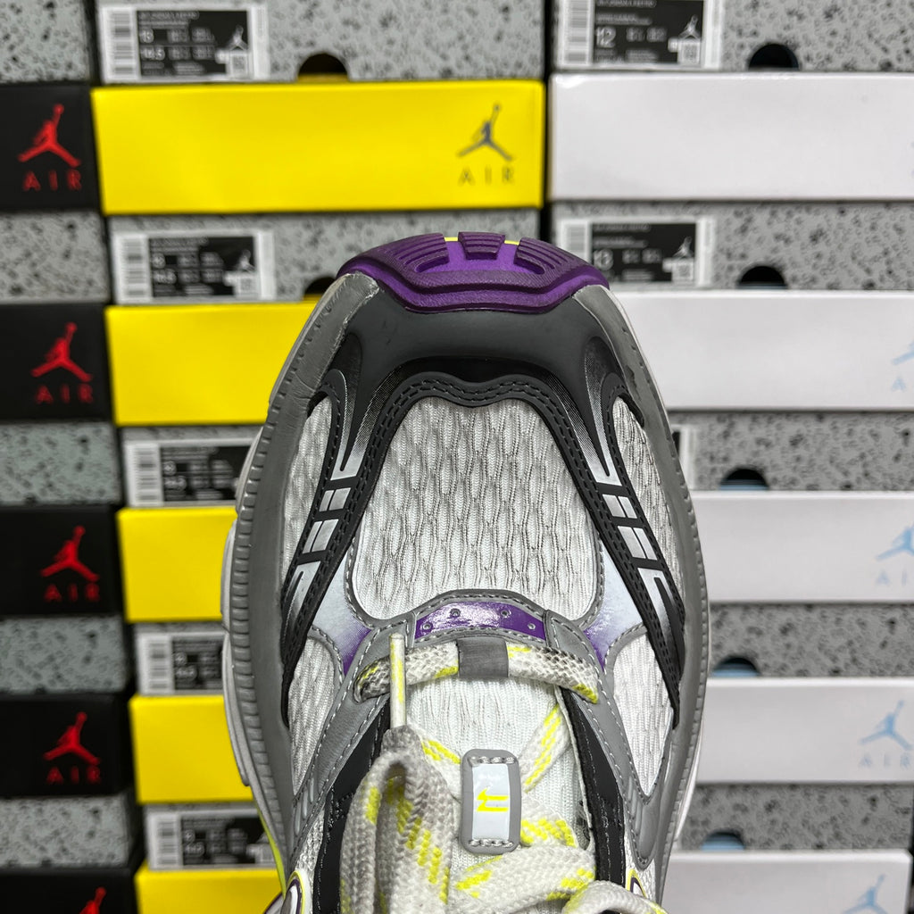 Back view of lace-up sneakers in gray with purple heel and neon-green trim