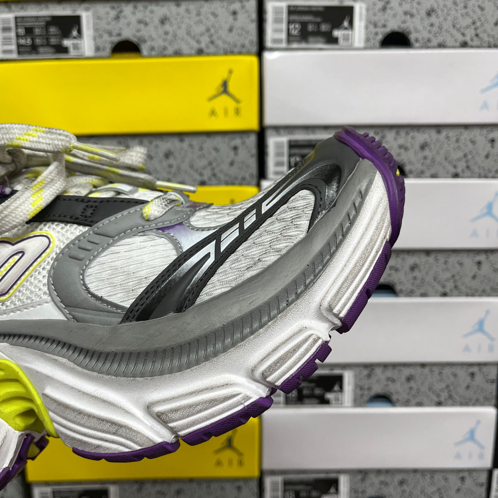 Side view of gray sneakers with purple trim and a chunky white platform sole