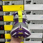 Sole-and-heel view of sneakers with purple tread and neon green highlight accents