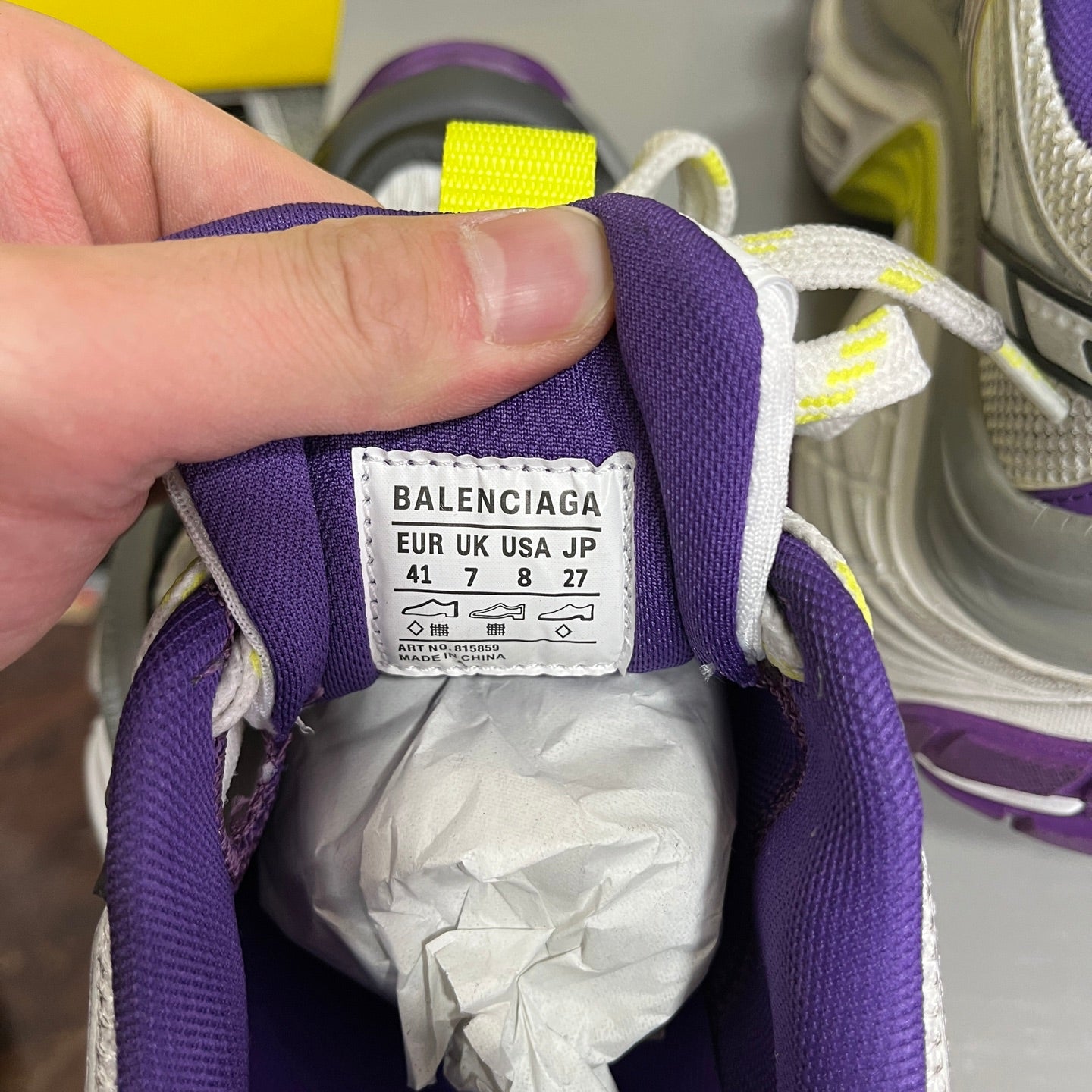 Inside label on Balenciaga sneakers with size info on a purple collar
