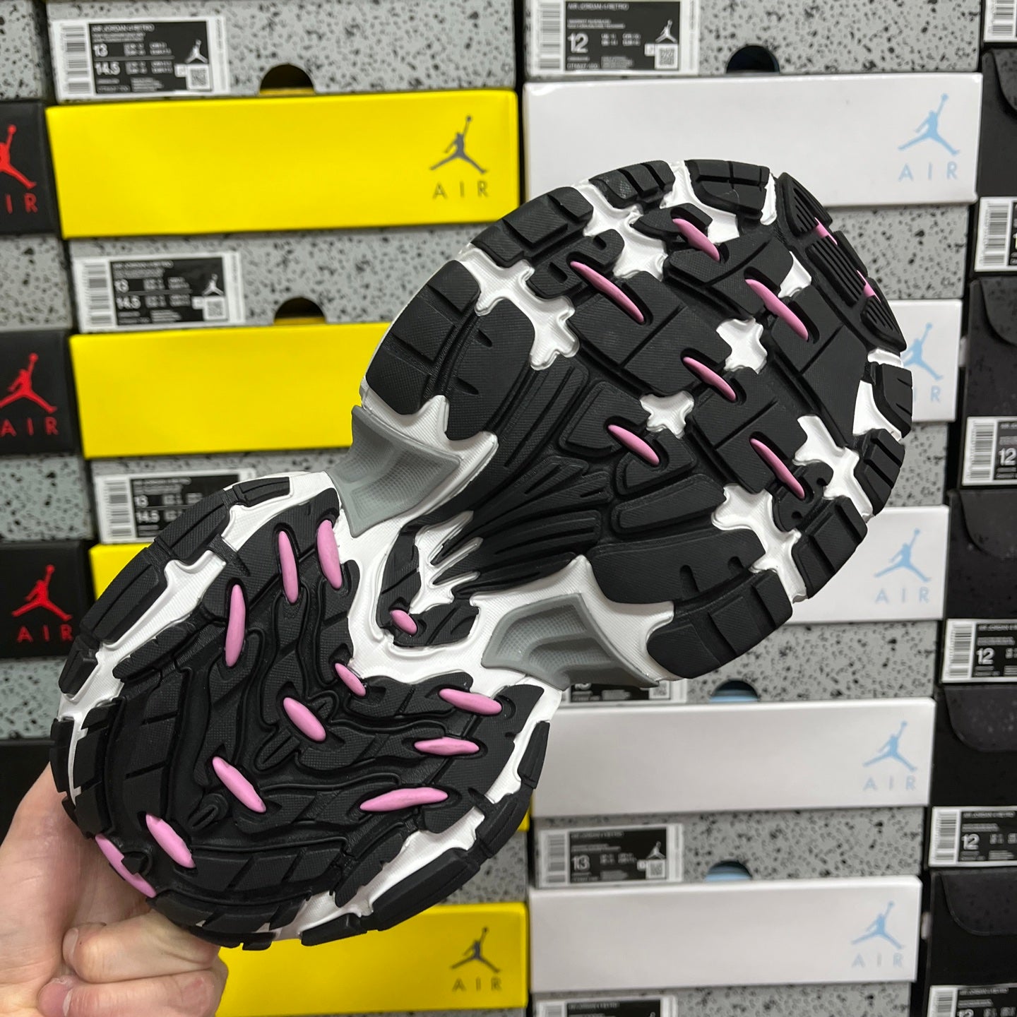 Black rubber outsole with white pattern and pink traction details