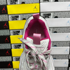 White sneaker back view with pink heel collar and lace-up upper