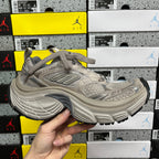 Light gray running sneakers with mesh panels, lace-up design and chunky sidewall