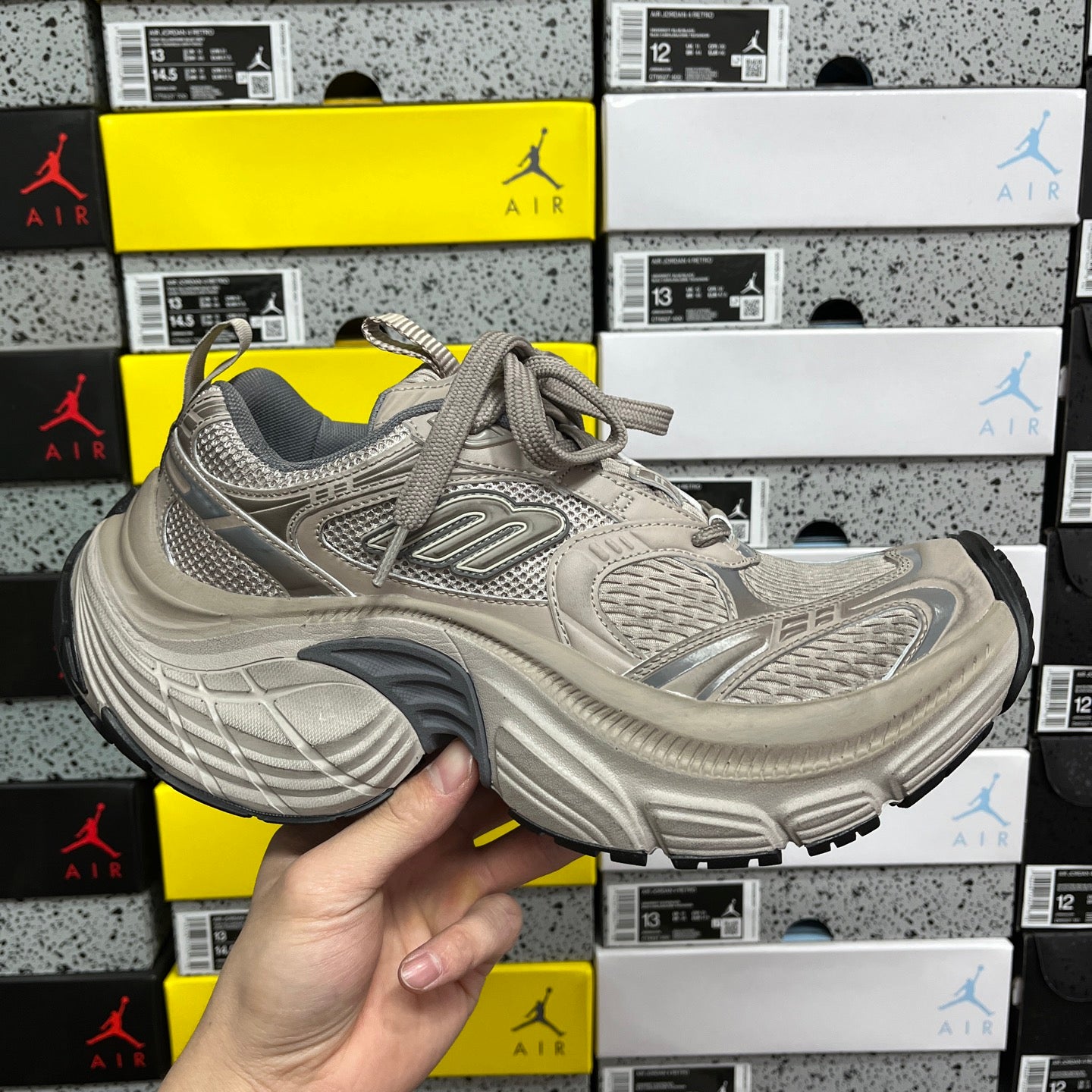 Light gray running sneakers with mesh upper, lace-up front and padded collar
