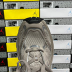 Light gray sneaker upper with lace eyelets, padded collar and knit fabric lining
