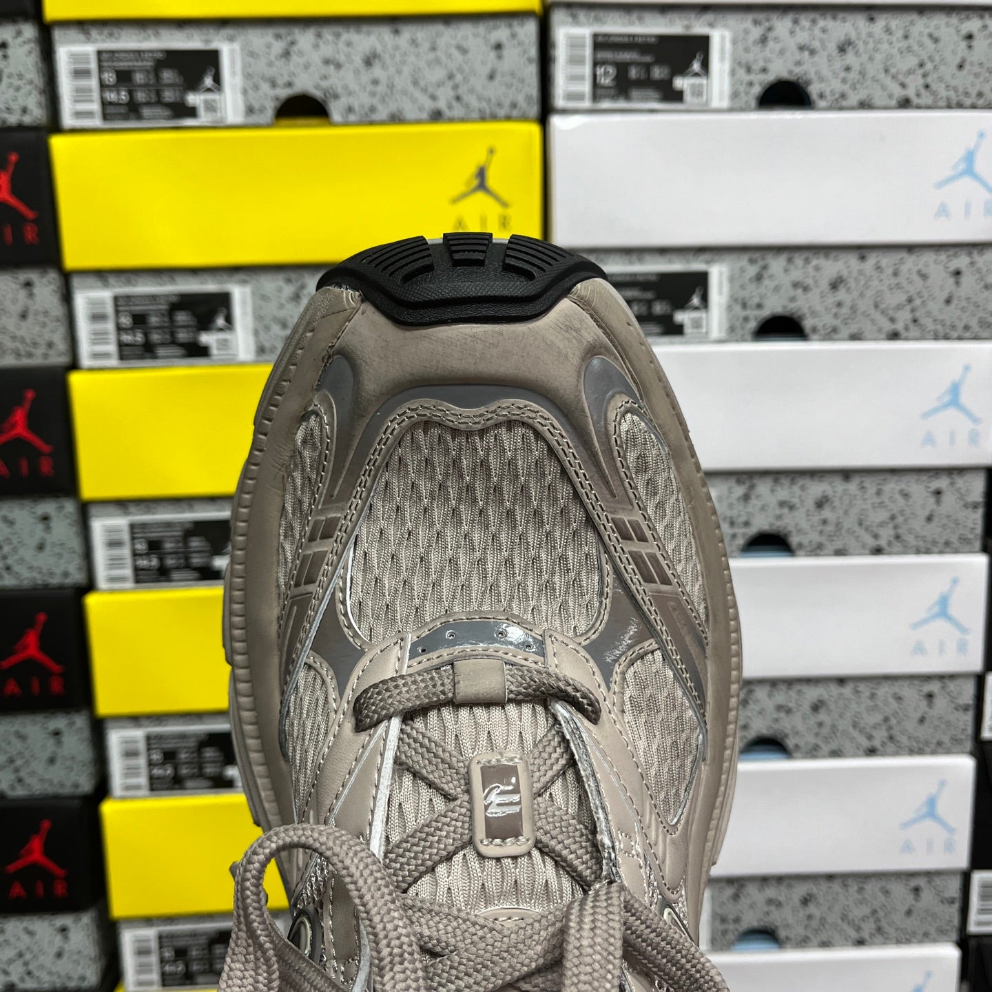 Light gray sneaker upper with lace eyelets, padded collar and knit fabric lining