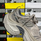 Light gray sneakers with lace-up closure, stitched overlays and ventilated mesh sections