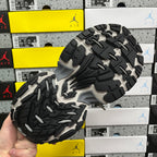 Chunky sneaker outsole with black-and-gray tread, showing circular traction blocks