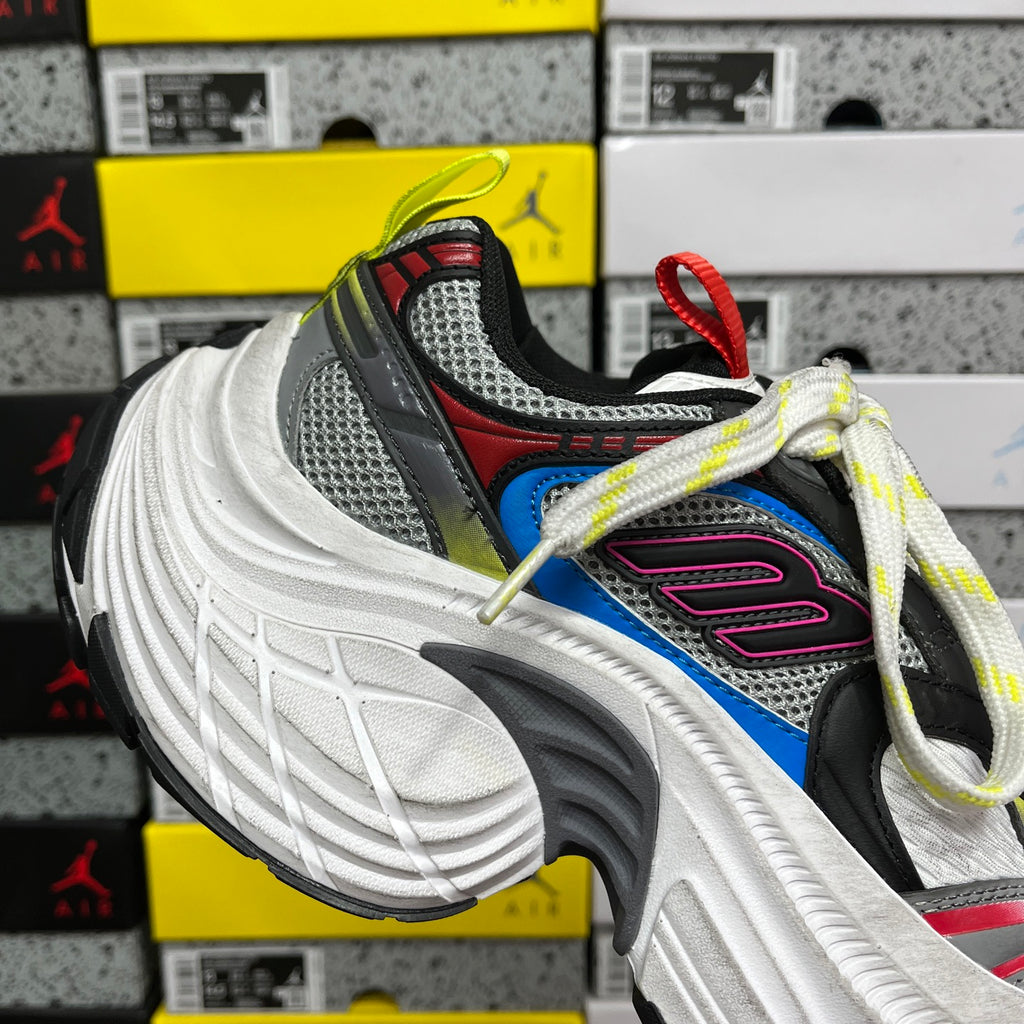 Balenciaga sneakers side view, white sole, gray mesh upper, blue and pink accents