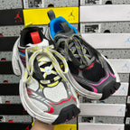 Balenciaga sneakers side view, black mesh upper, blue tongue accent, pink swoosh, white sole