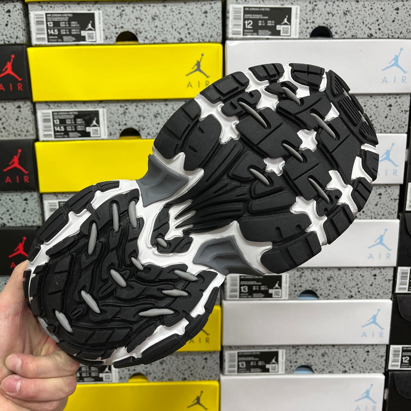 Sneaker outsole with black and gray traction tread, chunky platform base.