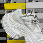 White Balenciaga sneaker side view with mesh panel, laces, and chunky tread sole