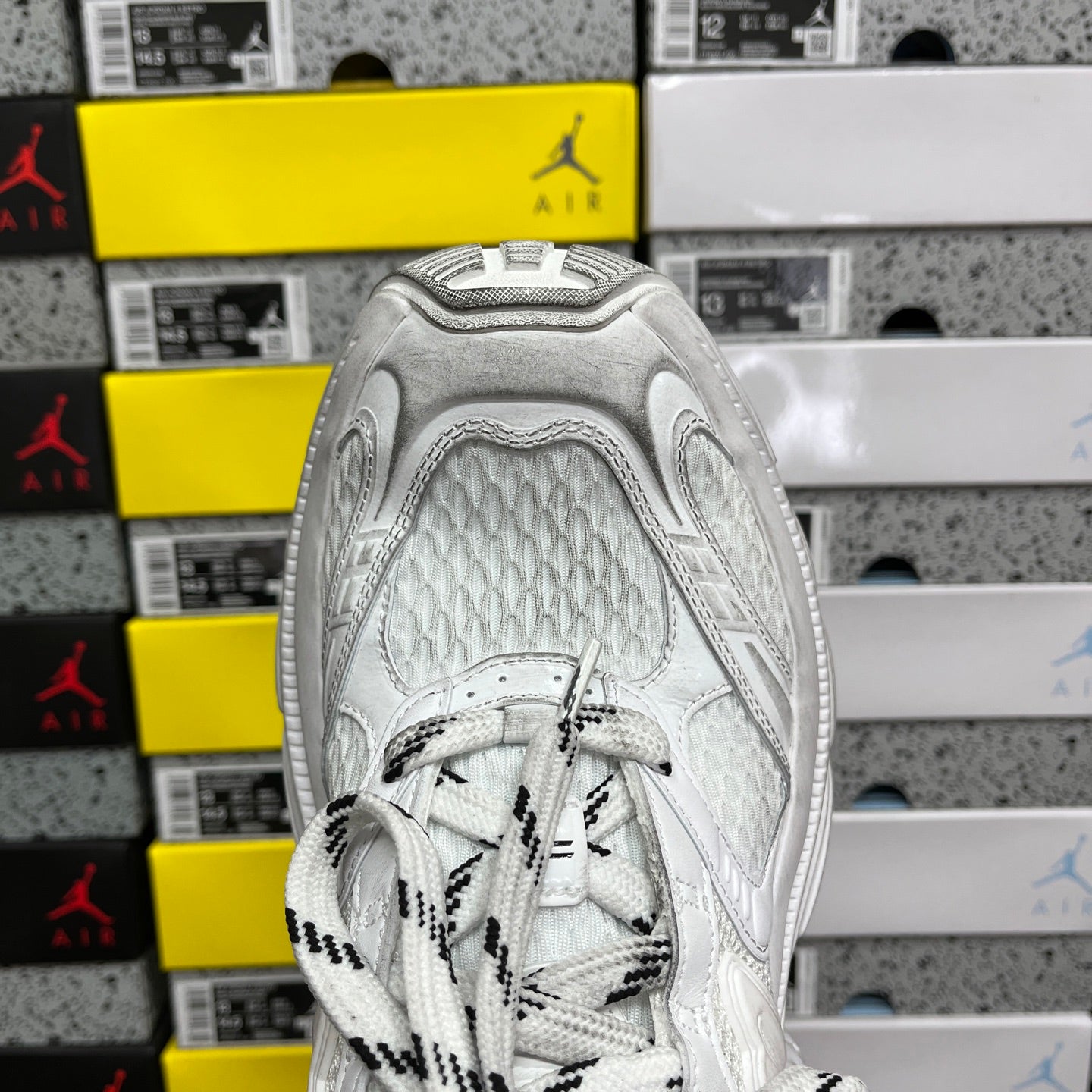 White sneaker heel with padded collar, lace-up tongue panel, and textured leather