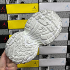 White sneaker full outsole with raised traction blocks and curved groove lines