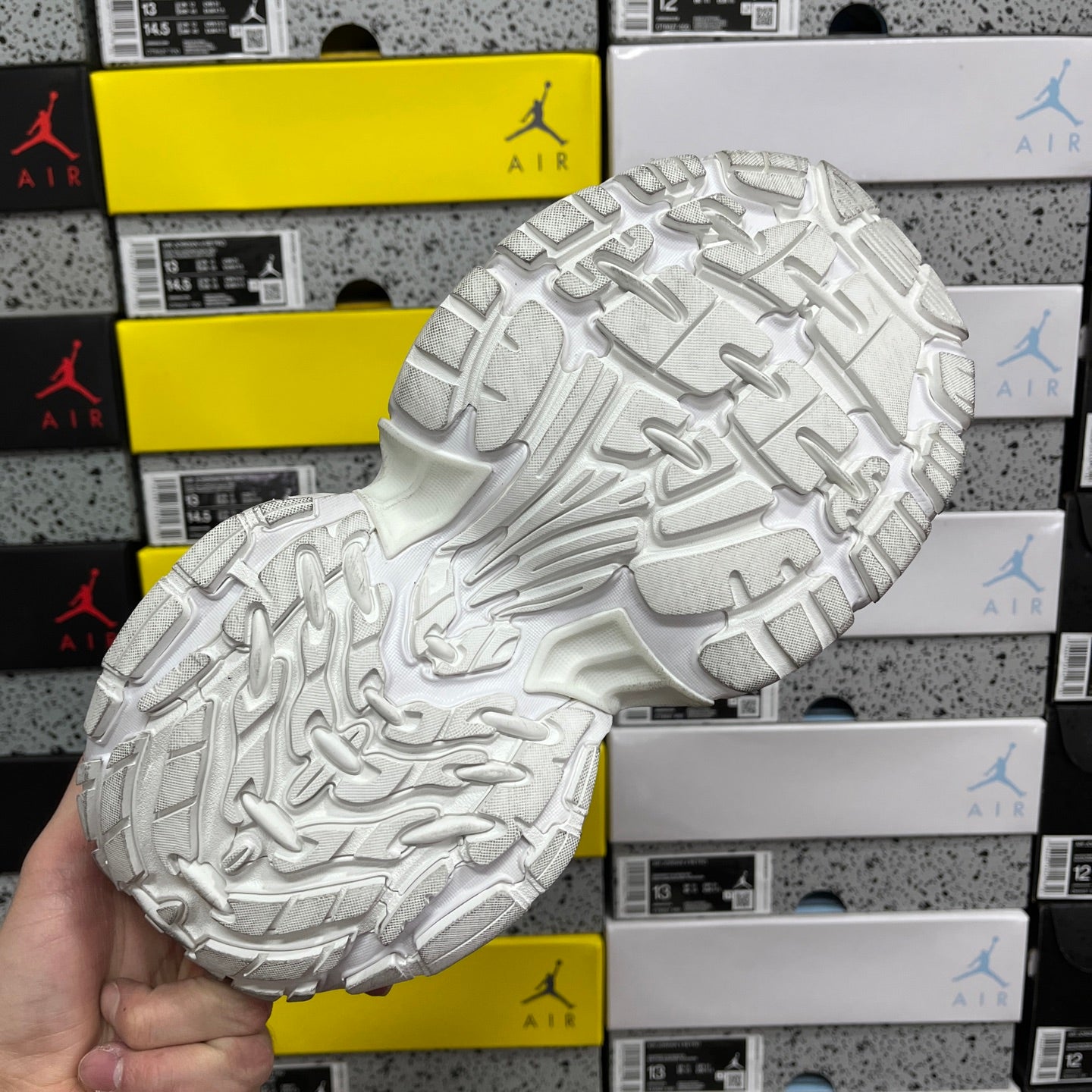 White sneaker full outsole with raised traction blocks and curved groove lines